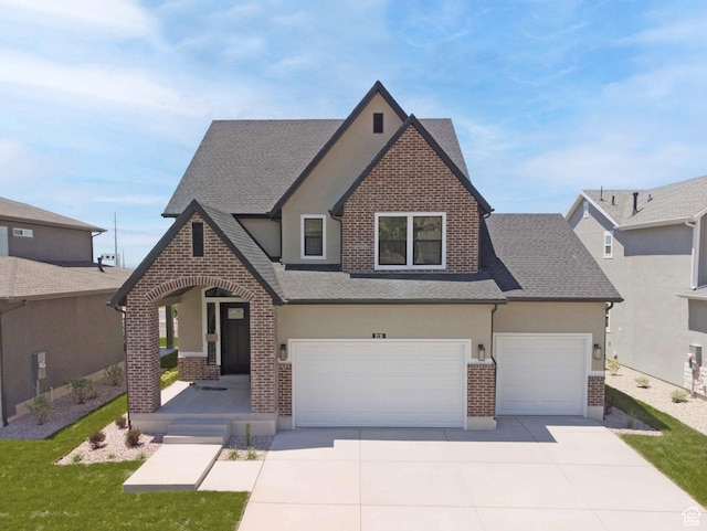 2131 N 725 W, Centerville, UT 84014 - view of front of house with brick siding, stucco siding, a garage, and roof with shingles