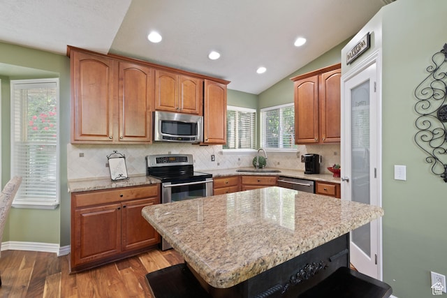 468 E Brewster, Draper, UT 84020 - kitchen featuring stainless steel appliances, a sink, decorative backsplash, light wood-type flooring, and light stone countertops