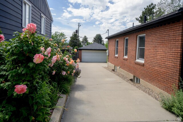2366 E Logan Way, Salt Lake City, UT 84108 - view of home's exterior featuring brick siding, a detached garage, and an outdoor structure