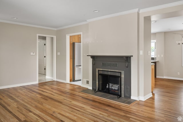 2366 E Logan Way, Salt Lake City, UT 84108 - unfurnished living room with light wood-type flooring, crown molding, baseboards, a fireplace, and recessed lighting