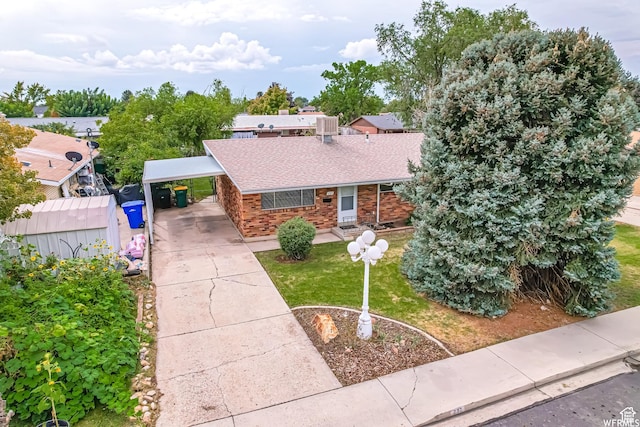 237 W 310 N, Orem, UT 84057 - view of front of property with roof with shingles, a front yard, concrete driveway, brick siding, and a carport