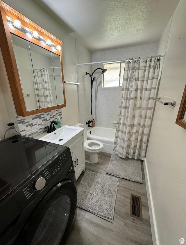 237 W 310 N, Orem, UT 84057 - full bathroom featuring washer / clothes dryer, toilet, shower / tub combo, decorative backsplash, and wood finished floors