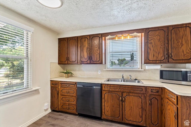 106 N 400 E, Kaysville, UT 84037 - kitchen featuring stainless steel appliances, light wood-type flooring, light countertops, a textured ceiling, and tasteful backsplash