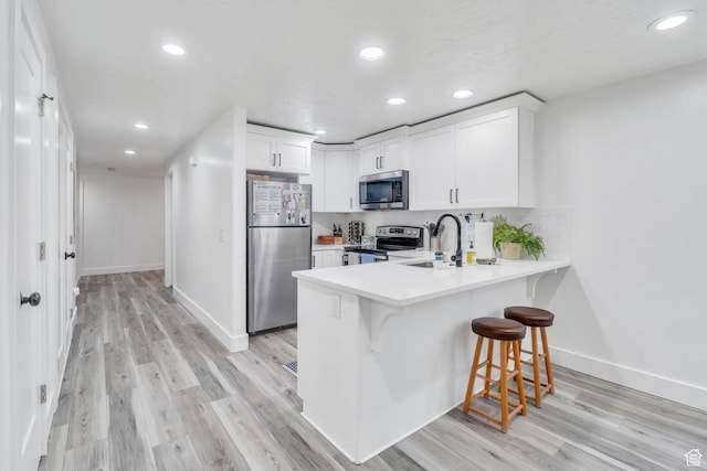 162 W 350 N, Vineyard, UT 84059 - kitchen featuring stainless steel appliances, a sink, a peninsula, baseboards, and white cabinets