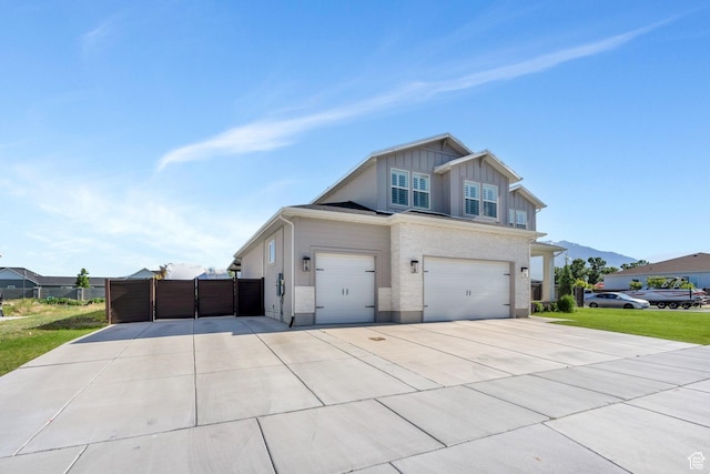 162 W 350 N, Vineyard, UT 84059 - view of front of home with board and batten siding, driveway, an attached garage, and a mountain view
