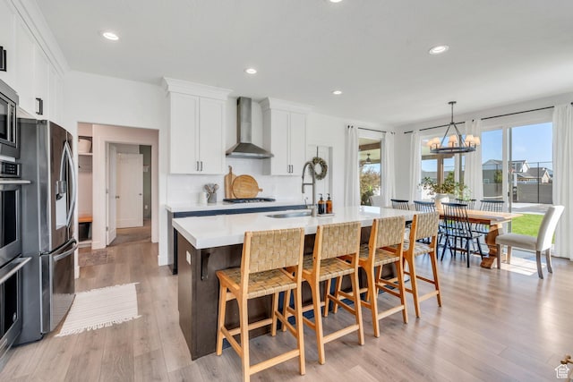 162 W 350 N, Vineyard, UT 84059 - kitchen featuring wall chimney range hood, a sink, stainless steel refrigerator with ice dispenser, healthy amount of natural light, and recessed lighting