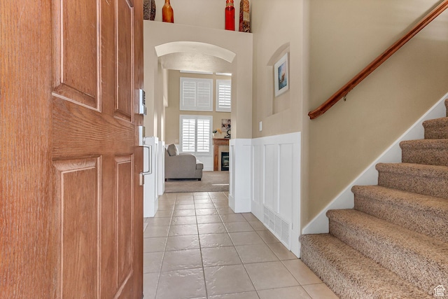 2733 S 1415 W, Syracuse, UT 84075 - entrance foyer with stairway, light tile patterned floors, a fireplace, and a high ceiling