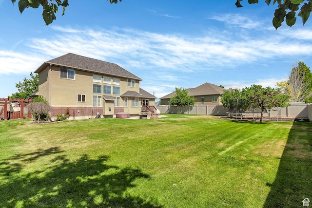 2733 S 1415 W, Syracuse, UT 84075 - back of property with a trampoline, brick siding, and stucco siding