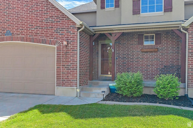 2733 S 1415 W, Syracuse, UT 84075 - view of exterior entry with brick siding, driveway, a garage, and stucco siding