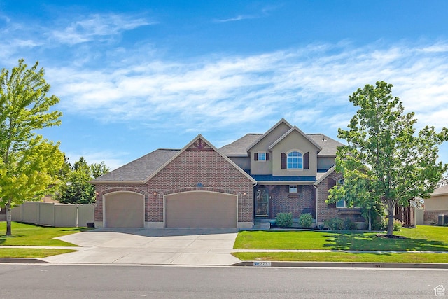 2733 S 1415 W, Syracuse, UT 84075 - view of front of house with an attached garage, concrete driveway, stucco siding, and brick siding