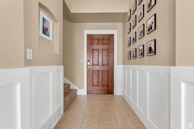 2733 S 1415 W, Syracuse, UT 84075 - entryway with a wainscoted wall, light tile patterned flooring, stairway, and a decorative wall