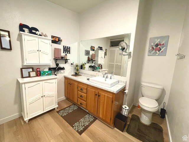 870 S 100 E, Wellington, UT 84542 - full bath with vanity, wood finished floors, toilet, and baseboards