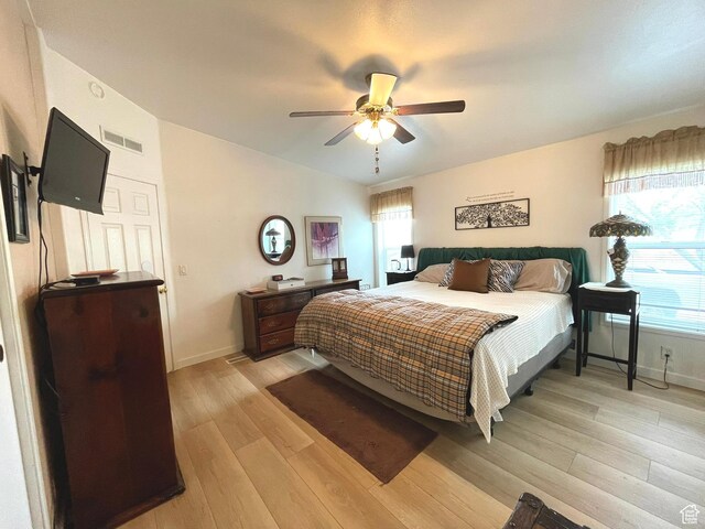 870 S 100 E, Wellington, UT 84542 - bedroom with light wood-type flooring, vaulted ceiling, baseboards, and a ceiling fan