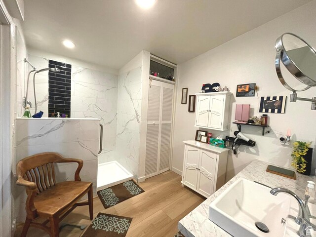 870 S 100 E, Wellington, UT 84542 - full bath with a marble finish shower, double vanity, wood finished floors, recessed lighting, and a closet