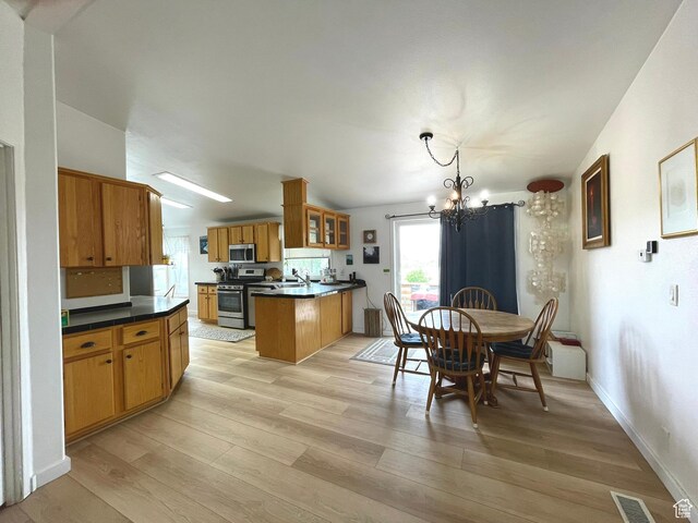 870 S 100 E, Wellington, UT 84542 - dining room with a chandelier, light wood-style floors, and baseboards