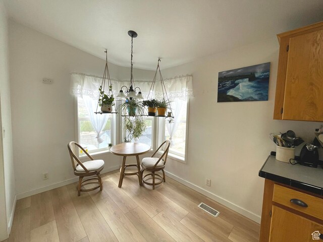 870 S 100 E, Wellington, UT 84542 - dining area with light wood-style flooring, healthy amount of natural light, baseboards, and vaulted ceiling