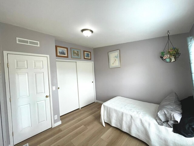 870 S 100 E, Wellington, UT 84542 - bedroom featuring wood finished floors, baseboards, and a closet