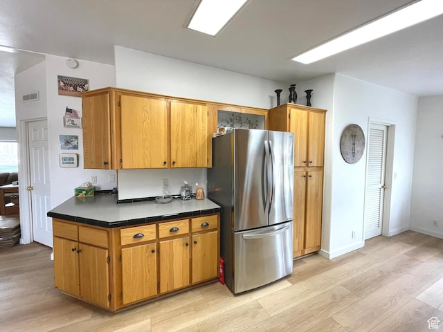 870 S 100 E, Wellington, UT 84542 - kitchen with freestanding refrigerator, light wood-style floors, and dark countertops