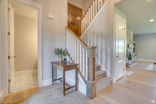 500 W Cascade Pkwy, Midway, UT 84049 - staircase with wood finished floors, baseboards, a stone fireplace, and recessed lighting