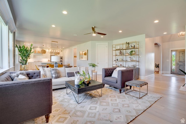 500 W Cascade Pkwy, Midway, UT 84049 - living area with arched walkways, light wood finished floors, a chandelier, recessed lighting, and ceiling fan