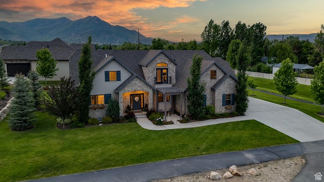 500 W Cascade Pkwy, Midway, UT 84049 - french country style house featuring stone siding, a lawn, concrete driveway, and a mountain view