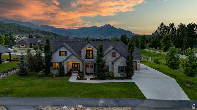 500 W Cascade Pkwy, Midway, UT 84049 - french country style house with stone siding, driveway, a front yard, and a mountain view
