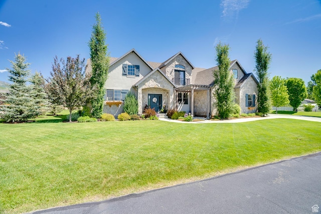 500 W Cascade Pkwy, Midway, UT 84049 - view of front of home featuring stone siding, a front lawn, and a balcony