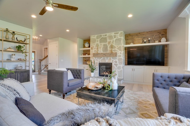 500 W Cascade Pkwy, Midway, UT 84049 - living room with light wood-type flooring, a stone fireplace, stairs, ceiling fan, and recessed lighting