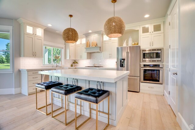 500 W Cascade Pkwy, Midway, UT 84049 - kitchen with stainless steel appliances, light countertops, baseboards, light wood-style floors, and recessed lighting