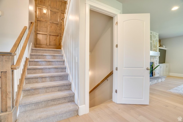 500 W Cascade Pkwy, Midway, UT 84049 - stairs with wood finished floors, a stone fireplace, and baseboards