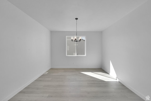 1162 N 375th St W Unit 22, Harrisville, UT 84404 - unfurnished dining area featuring a chandelier, light wood-style floors, and baseboards