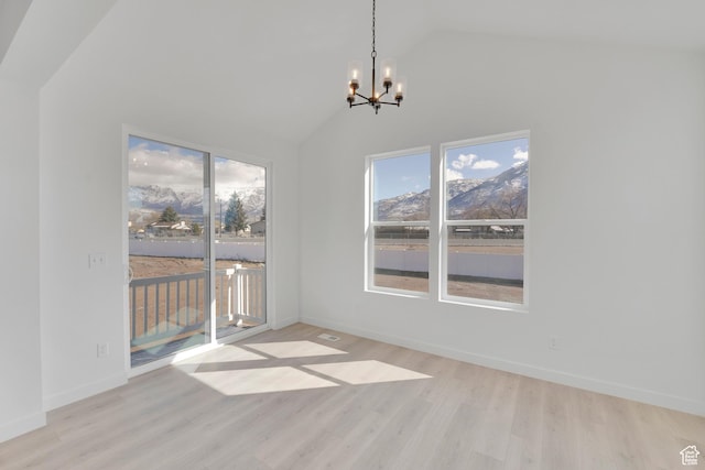 1162 N 375th St W Unit 22, Harrisville, UT 84404 - unfurnished dining area featuring a chandelier, vaulted ceiling, wood finished floors, and baseboards