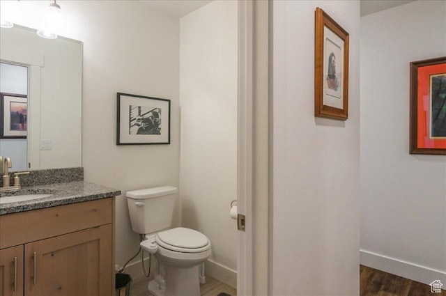 1123 S 4150 W, West Point, UT 84015 - bathroom with toilet, vanity, wood finished floors, and baseboards