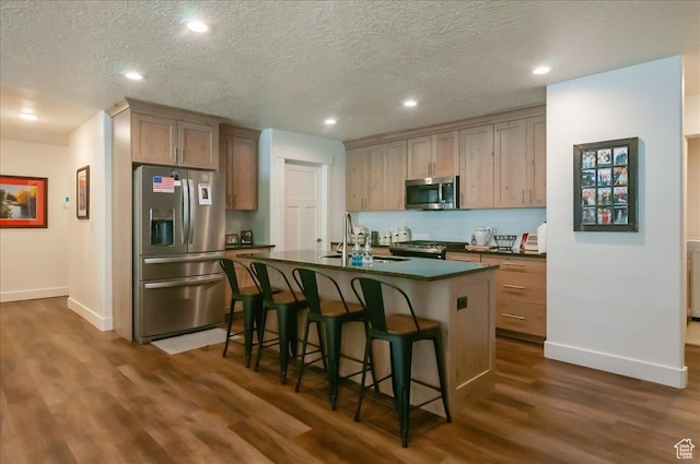 1123 S 4150 W, West Point, UT 84015 - kitchen with appliances with stainless steel finishes, dark countertops, a sink, dark wood-style flooring, and baseboards