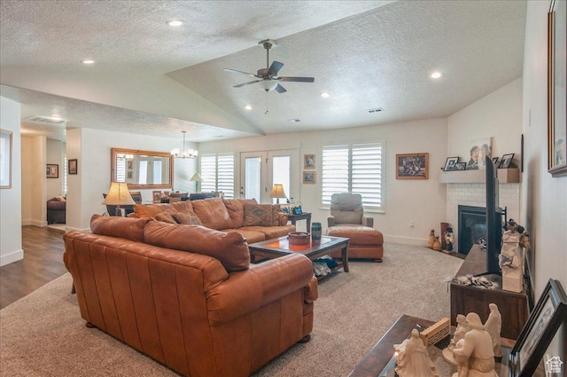 1123 S 4150 W, West Point, UT 84015 - living area featuring vaulted ceiling, a textured ceiling, ceiling fan, baseboards, and a tiled fireplace