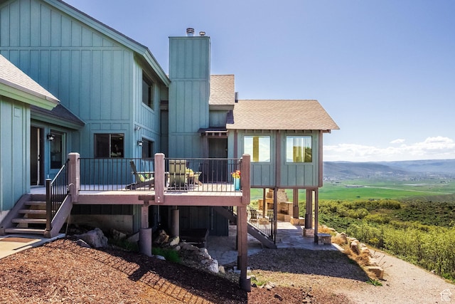 1960 Grandview Loop Unit 41, Kamas, UT 84036 - rear view of property with a deck with mountain view, roof with shingles, stairway, and a chimney