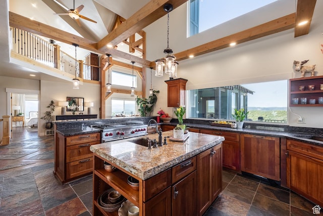 1960 Grandview Loop Unit 41, Kamas, UT 84036 - kitchen featuring open shelves, a sink, stone tile floors, high vaulted ceiling, and an island with sink