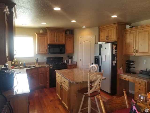 4895 W 5000 S, Hooper, UT 84315 - kitchen with black appliances, a sink, wood finished floors, recessed lighting, and a kitchen island