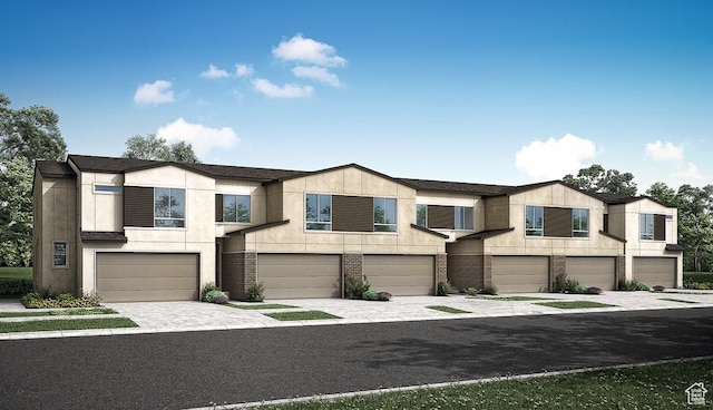 6064 W Lower Ln Unit 8-222, West Jordan, UT 84081 - view of property with an attached garage, driveway, and brick siding
