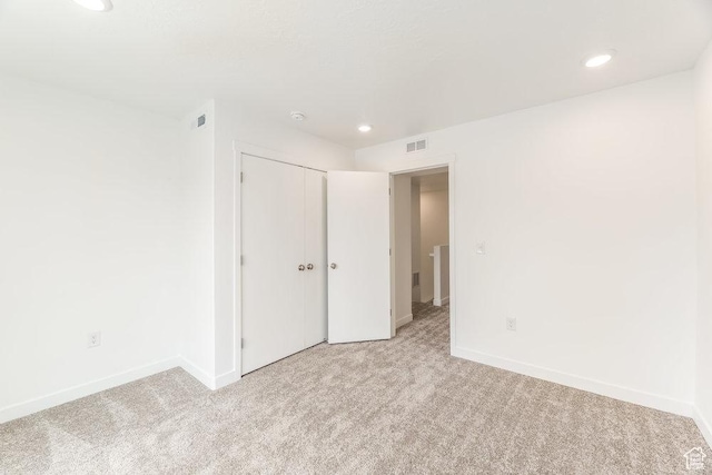 6064 W Lower Ln Unit 8-222, West Jordan, UT 84081 - unfurnished bedroom featuring light colored carpet, recessed lighting, baseboards, and a closet