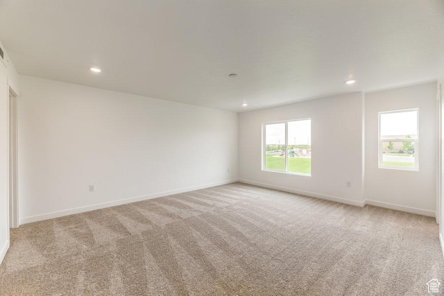 6064 W Lower Ln Unit 8-222, West Jordan, UT 84081 - empty room featuring light carpet, healthy amount of natural light, baseboards, and recessed lighting