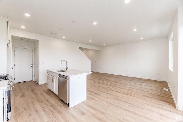 6064 W Lower Ln Unit 8-222, West Jordan, UT 84081 - kitchen with a sink, stainless steel appliances, light wood-type flooring, light countertops, and an island with sink