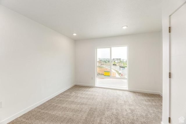 6064 W Lower Ln Unit 8-222, West Jordan, UT 84081 - empty room featuring light colored carpet, baseboards, and recessed lighting
