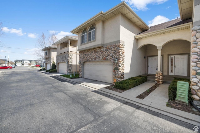 7819 S Spruce Tree Ln, Sandy, UT 84094 - view of front of property featuring stucco siding, stone siding, an attached garage, and driveway