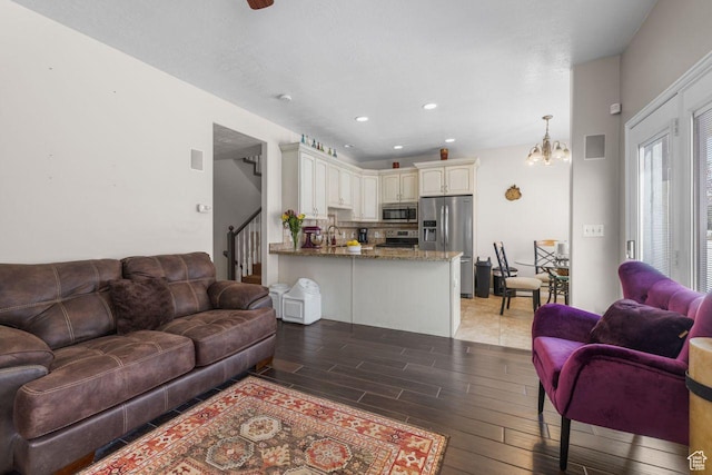 7819 S Spruce Tree Ln, Sandy, UT 84094 - living area with light wood finished floors, stairs, a chandelier, and recessed lighting