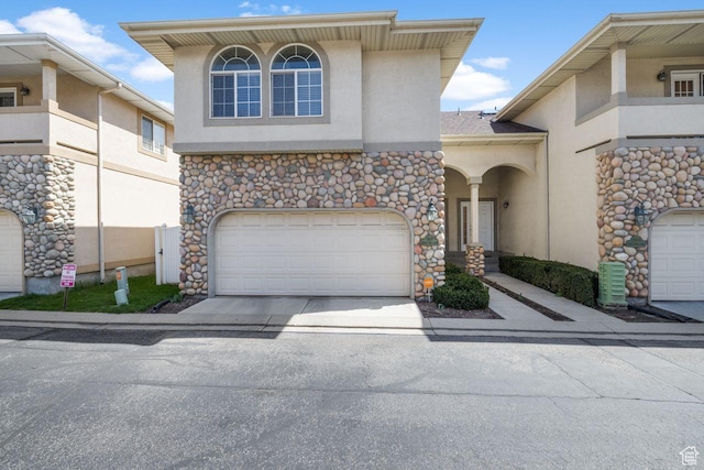 7819 S Spruce Tree Ln, Sandy, UT 84094 - view of front of house featuring stucco siding, concrete driveway, stone siding, and an attached garage
