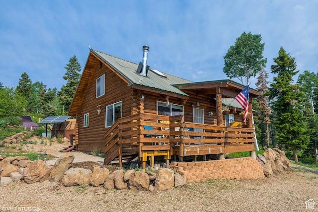 706 W Tranquility Dr, Virgin, UT 84779 - back of property with log siding, a wooden deck, and metal roof