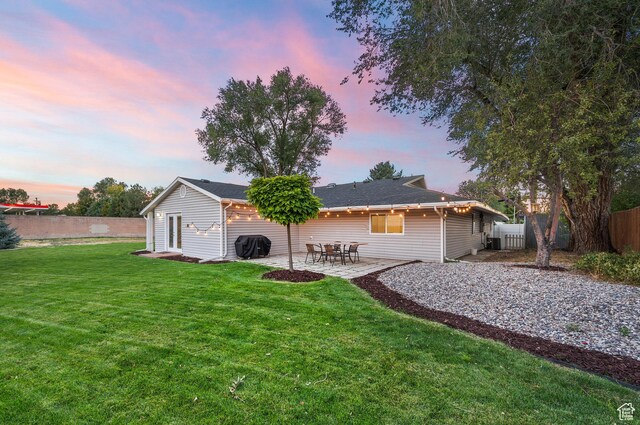 807 E Ln Dore Dr, Salt Lake City, UT 84107 - back of property at dusk featuring a patio