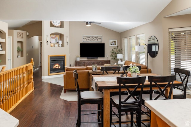 1007 E 2650 N, North Logan, UT 84341 - dining space featuring vaulted ceiling, dark wood finished floors, a glass covered fireplace, baseboards, and ceiling fan