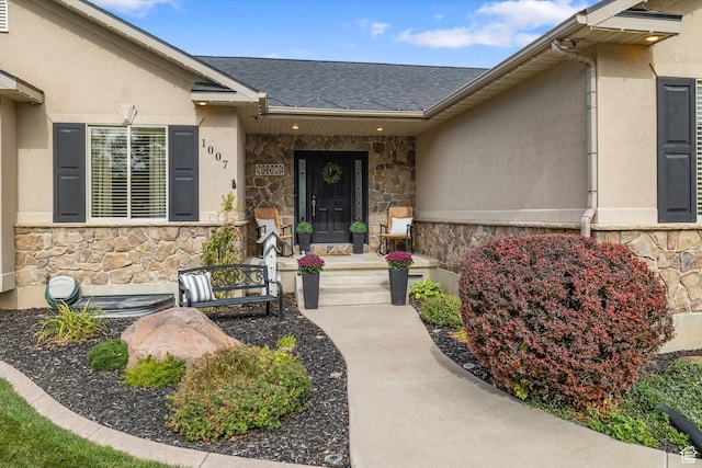 1007 E 2650 N, North Logan, UT 84341 - view of exterior entry featuring stone siding, stucco siding, and a shingled roof